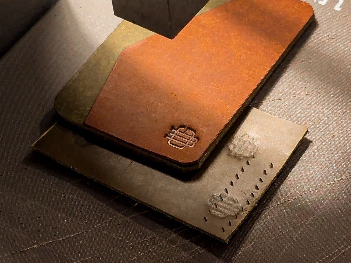 Pressing the maker's stamp into a fresh piece of leather